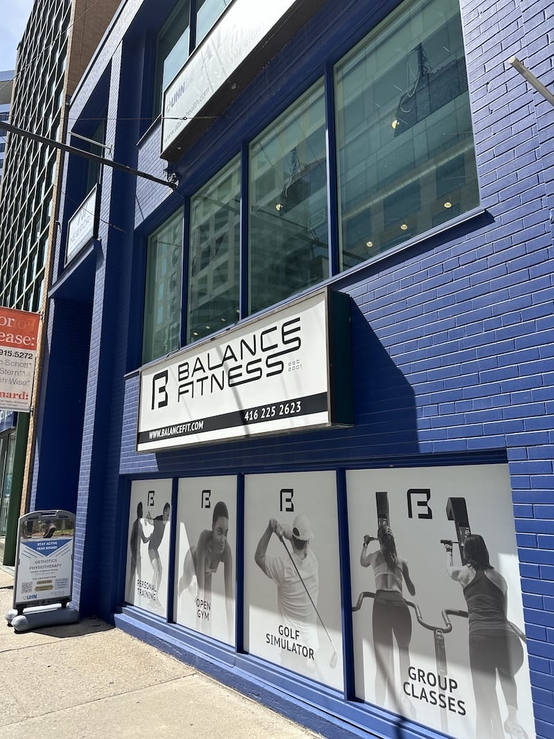 Exterior of Balance Fitness with glass facade and entrance off of St. Clair East in Toronto.