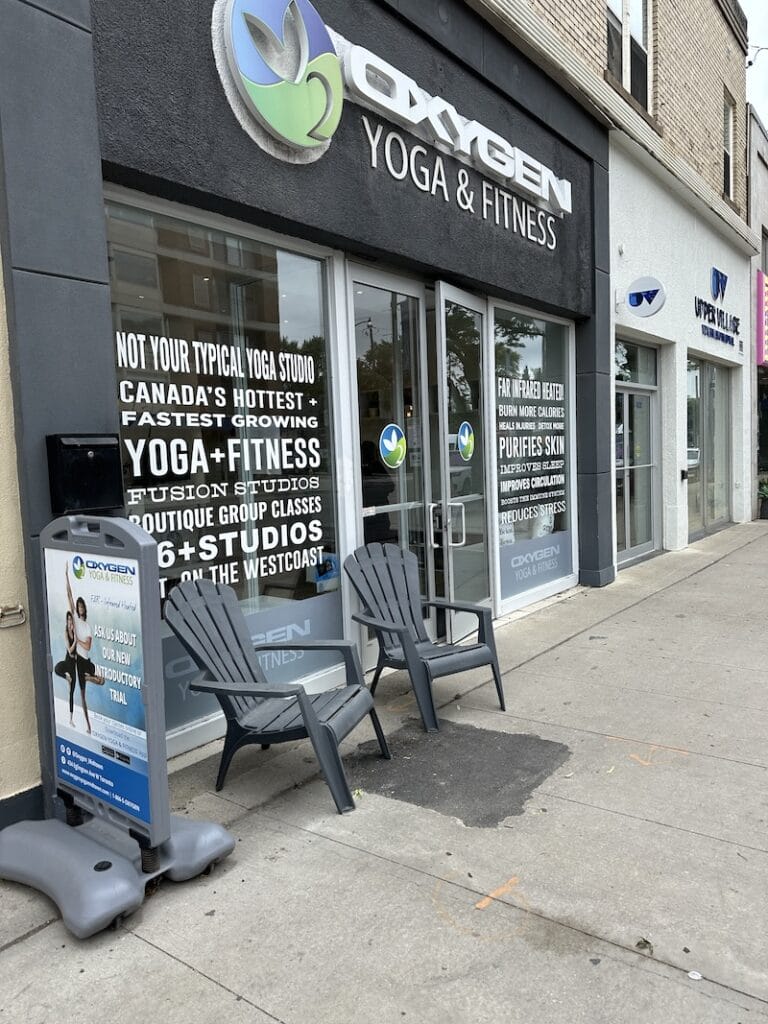 Street view o Oxygen Yoga Midtown Entrance, highlighting the modern facade and signage.