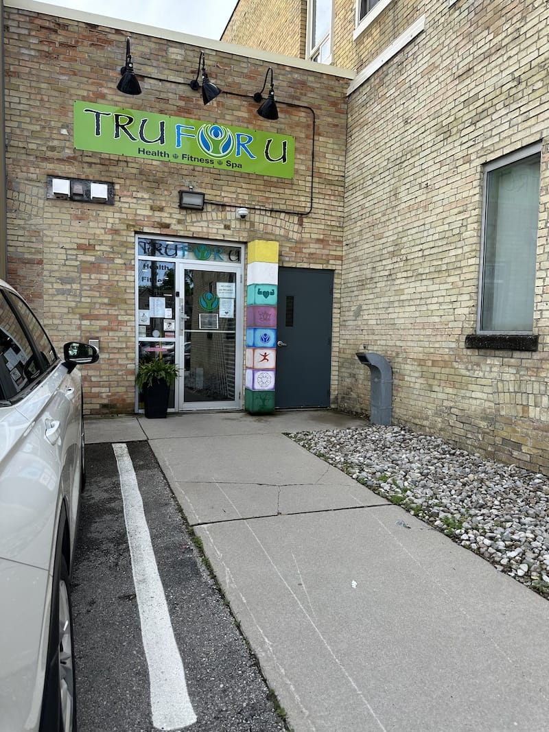 Exterior of Tru For U in St. Thomas Ontario with brick facade house and entrance on the rear side of the building.