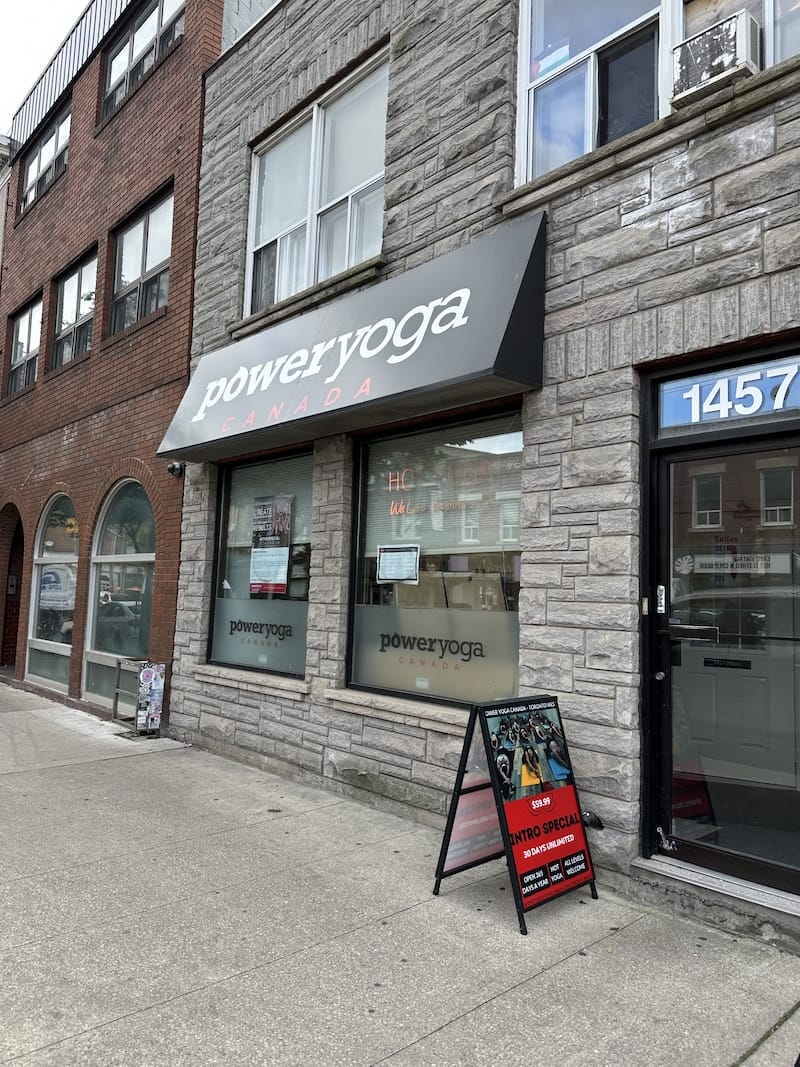 Exterior of Power Yoga Canada Toronto West with brick facade and entrance off Dundas Street in Toronto.