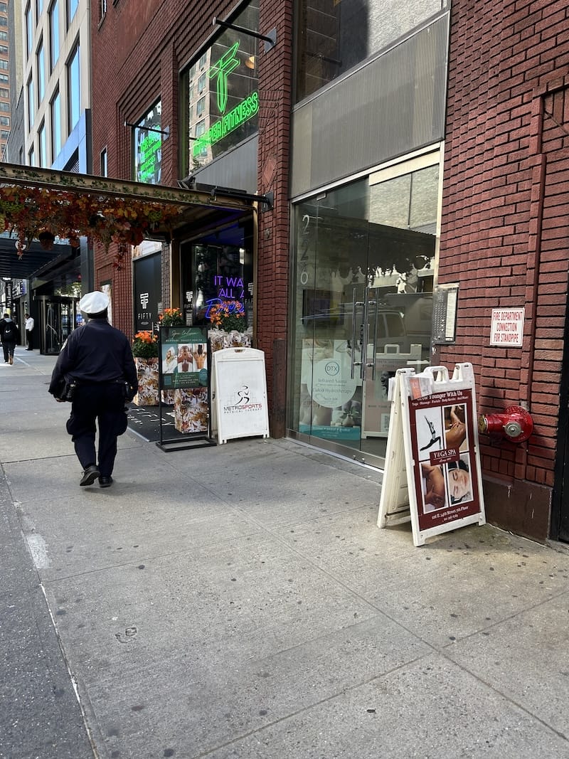 Street view of Yoga Spa Lounge 1881, highlighting the modern facade and signage.